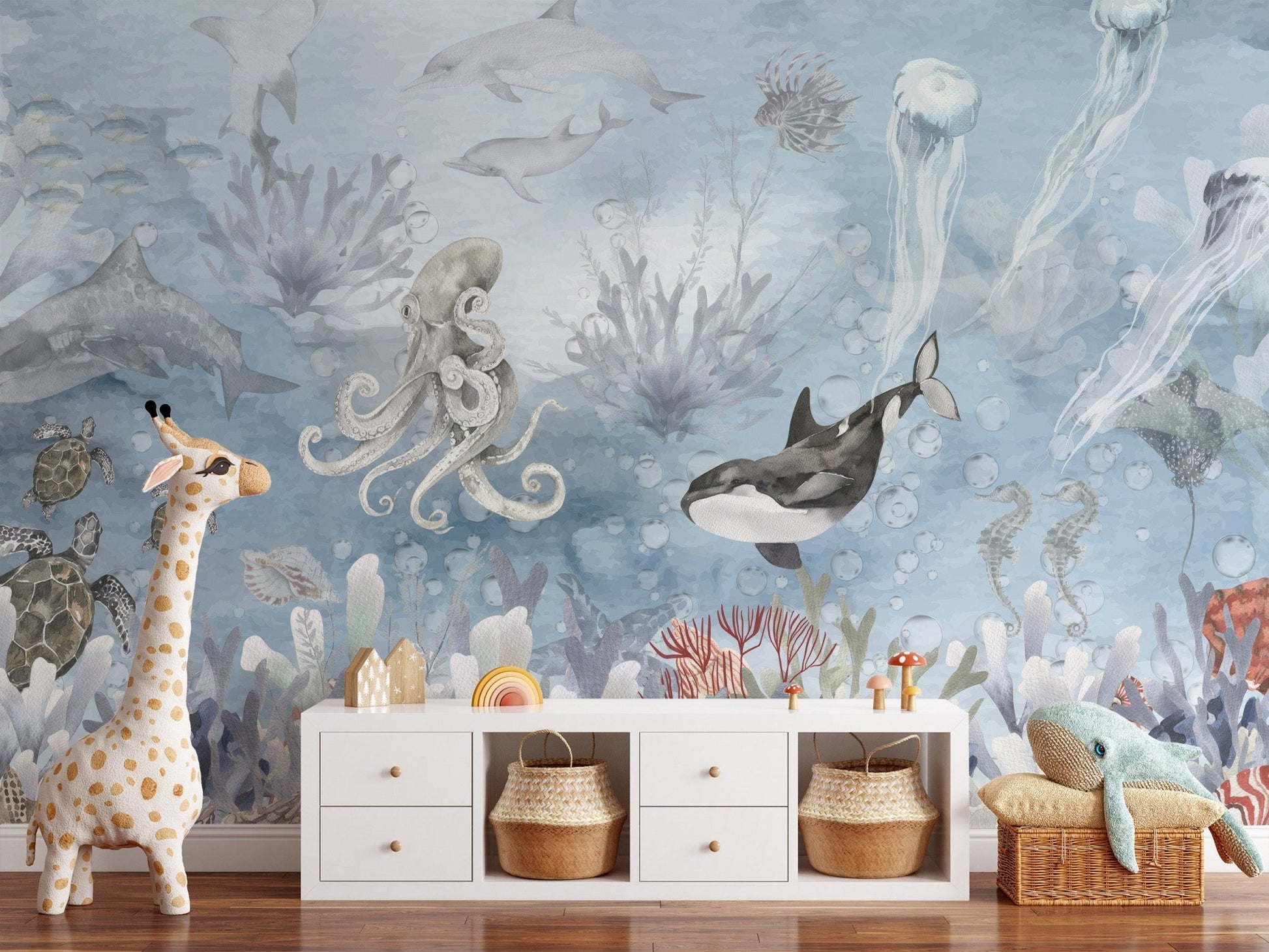 Underwater sea creatures wall mural in soft blue watercolor wallpaper.