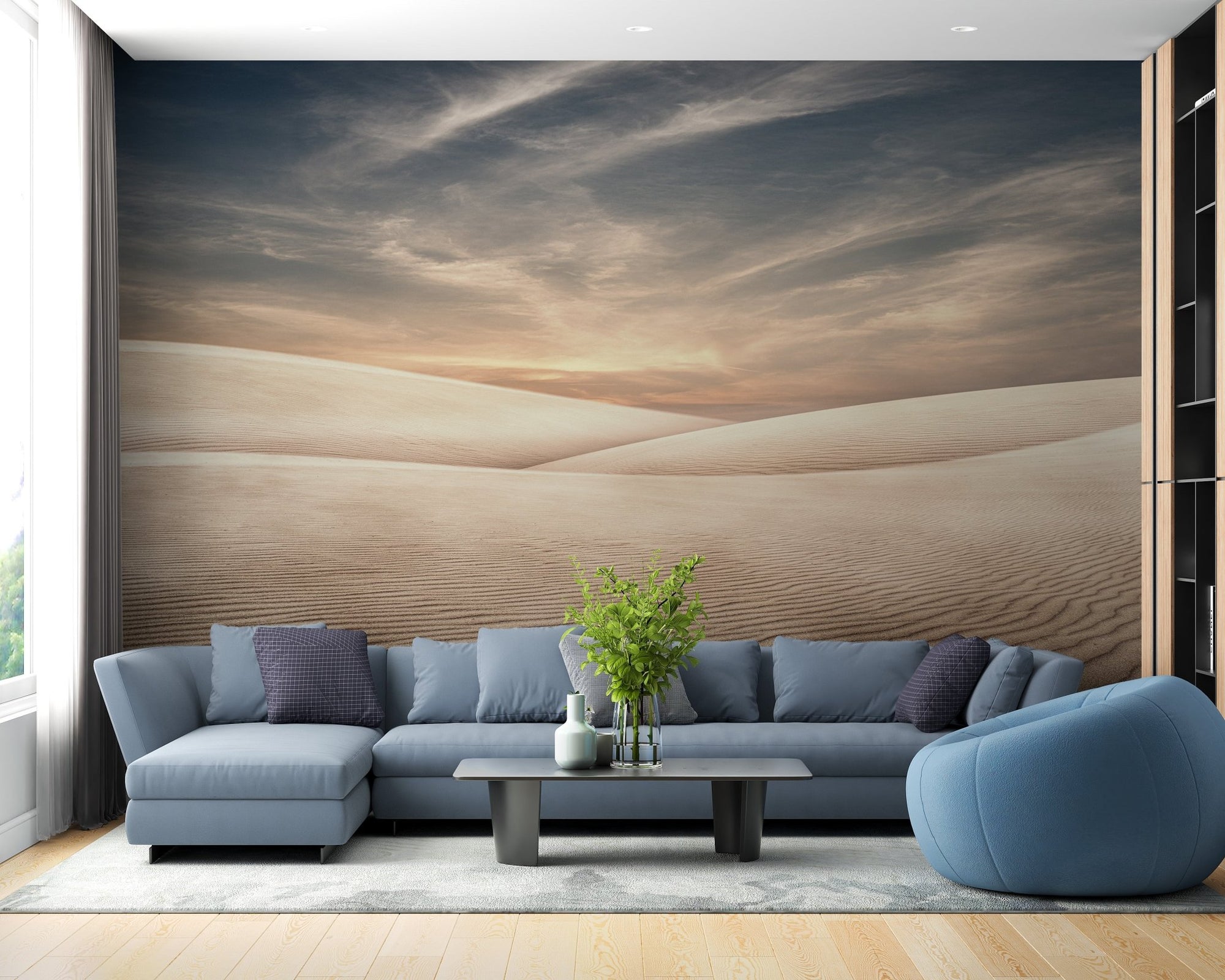 Living room wall mural featuring beige sand dunes and a blue sectional sofa.