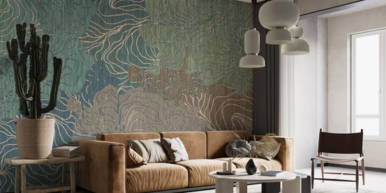 Tan leather sofa in living area paired with textured kaleidoscope wall mural.