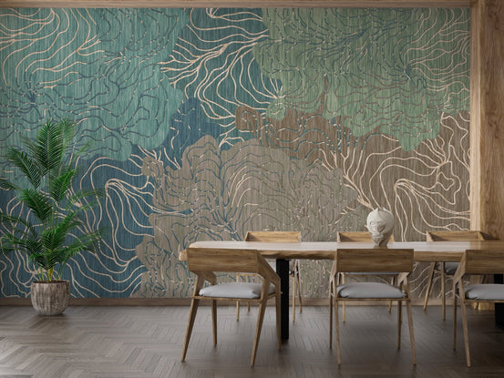 Wooden dining table set against teal and gold wavy kaleidoscope wall mural.