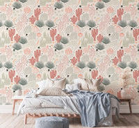 Cacti and lizard wallpaper in a modern bedroom with a blue throw blanket.