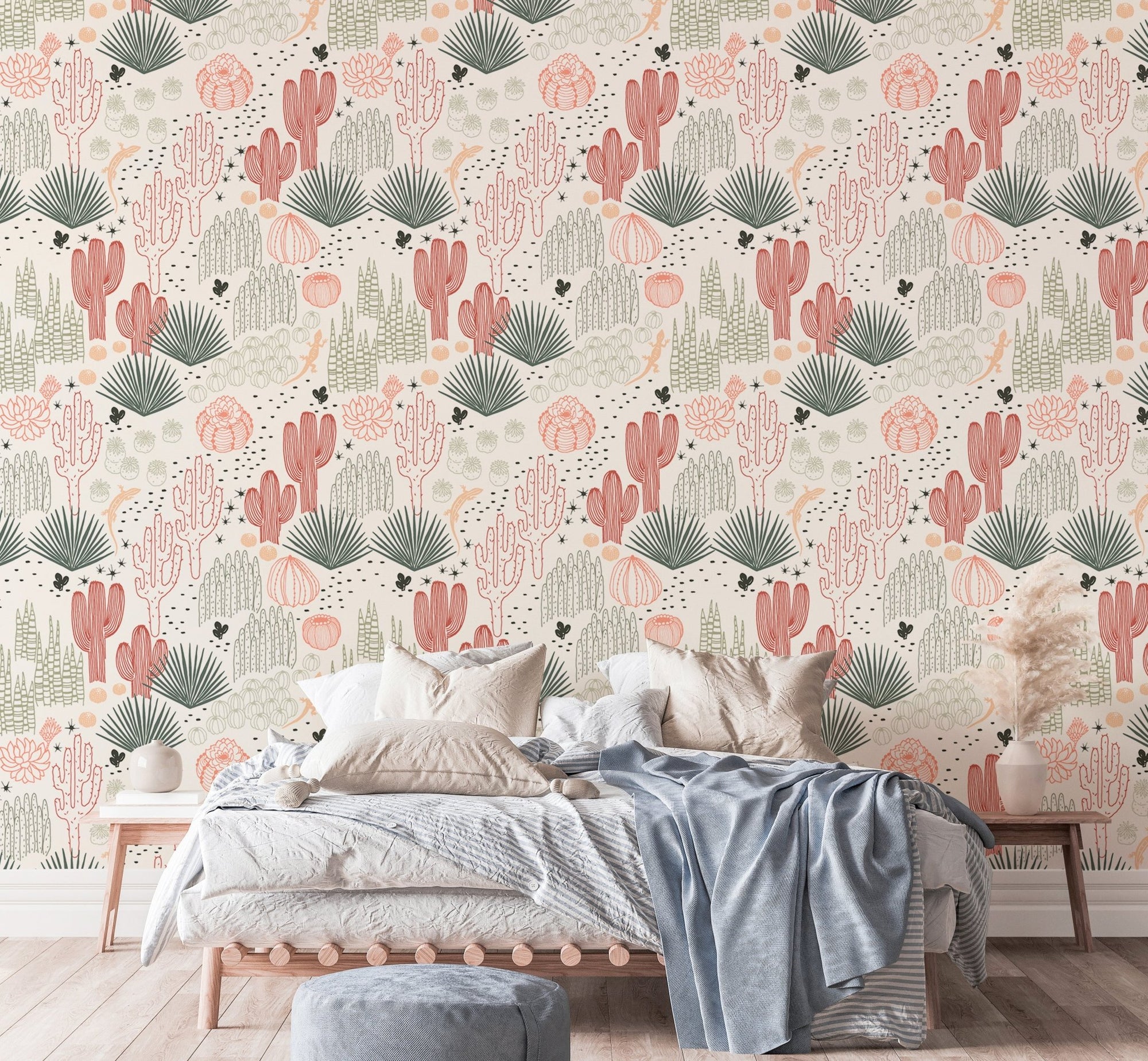 Cacti and lizard wallpaper in a modern bedroom with a blue throw blanket.