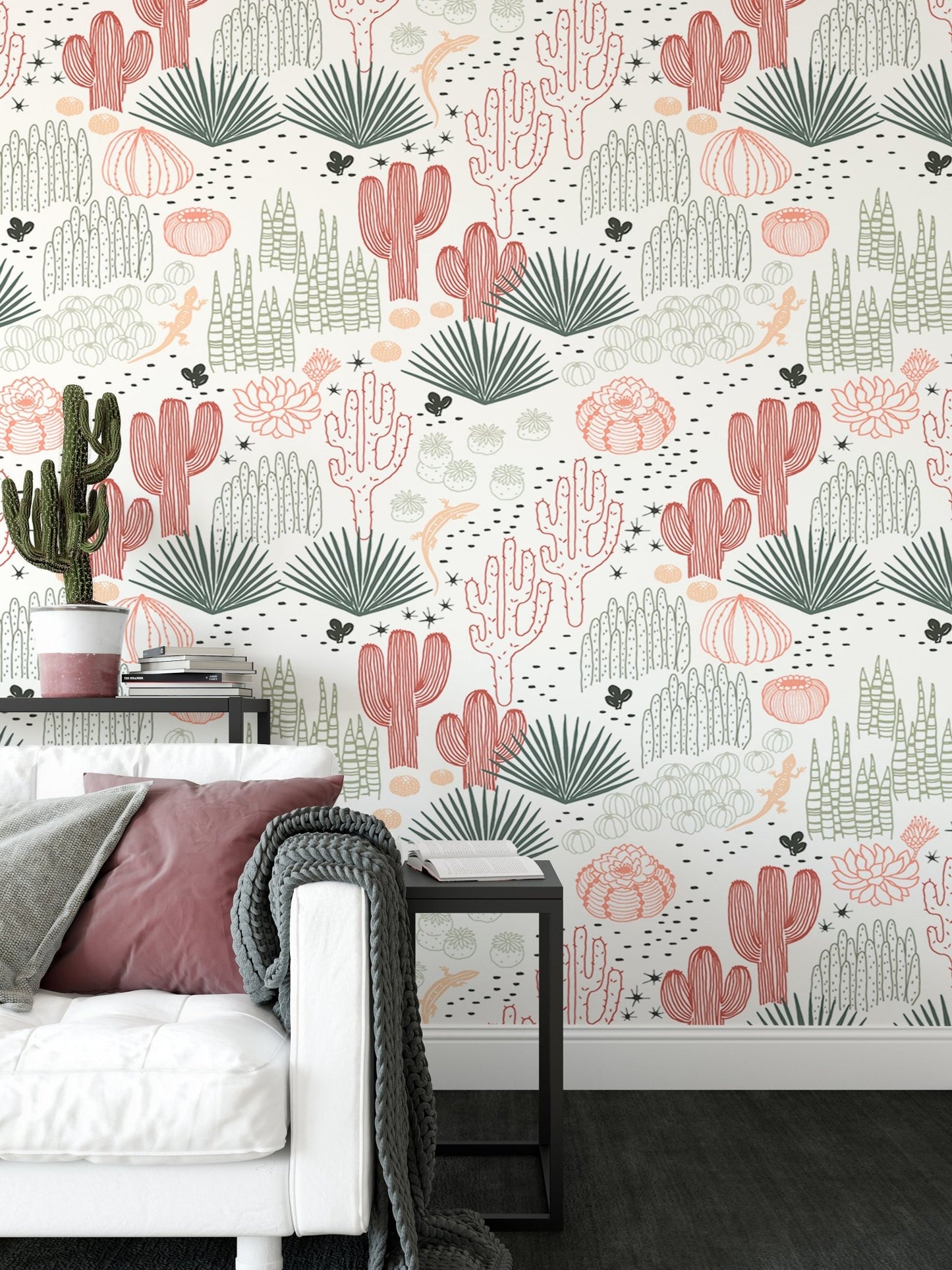 Grey and pink cacti wallpaper in a white living room with a black side table.