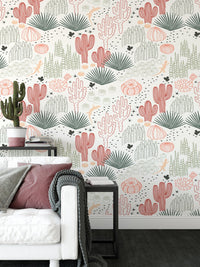 Grey and pink cacti wallpaper in a white living room with a black side table.