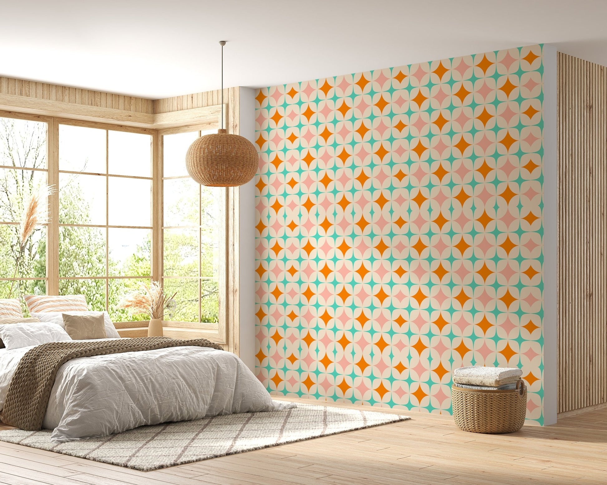 Orange and teal star pattern wall mural in a sunlit bedroom with a wooden bed frame.