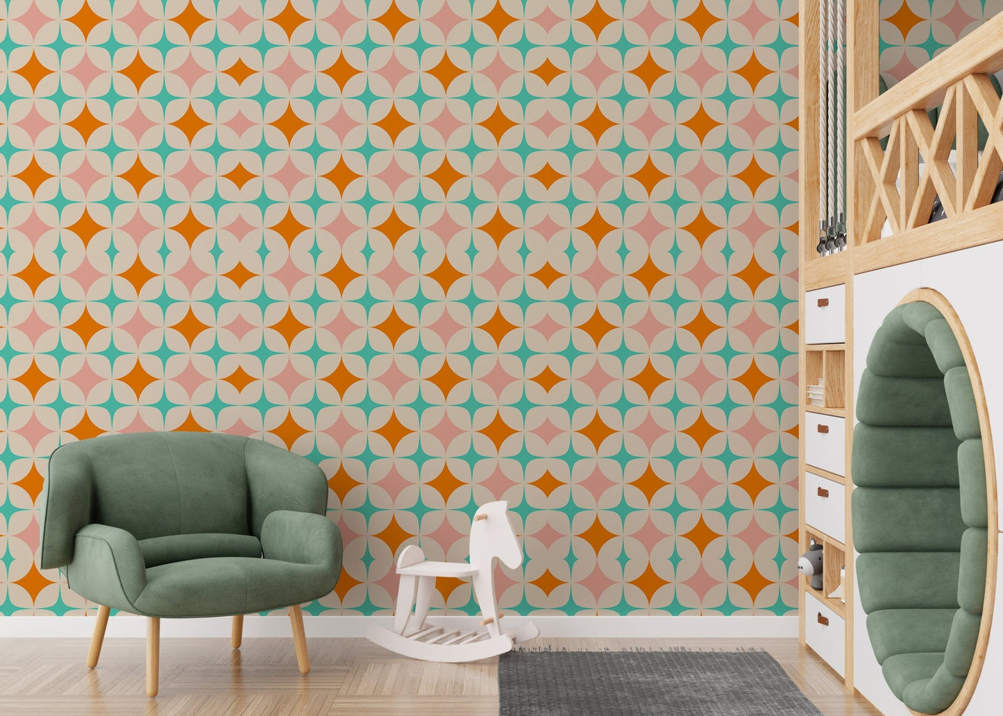 Vintage pattern wall mural in a nursery with a green armchair and wooden toys.