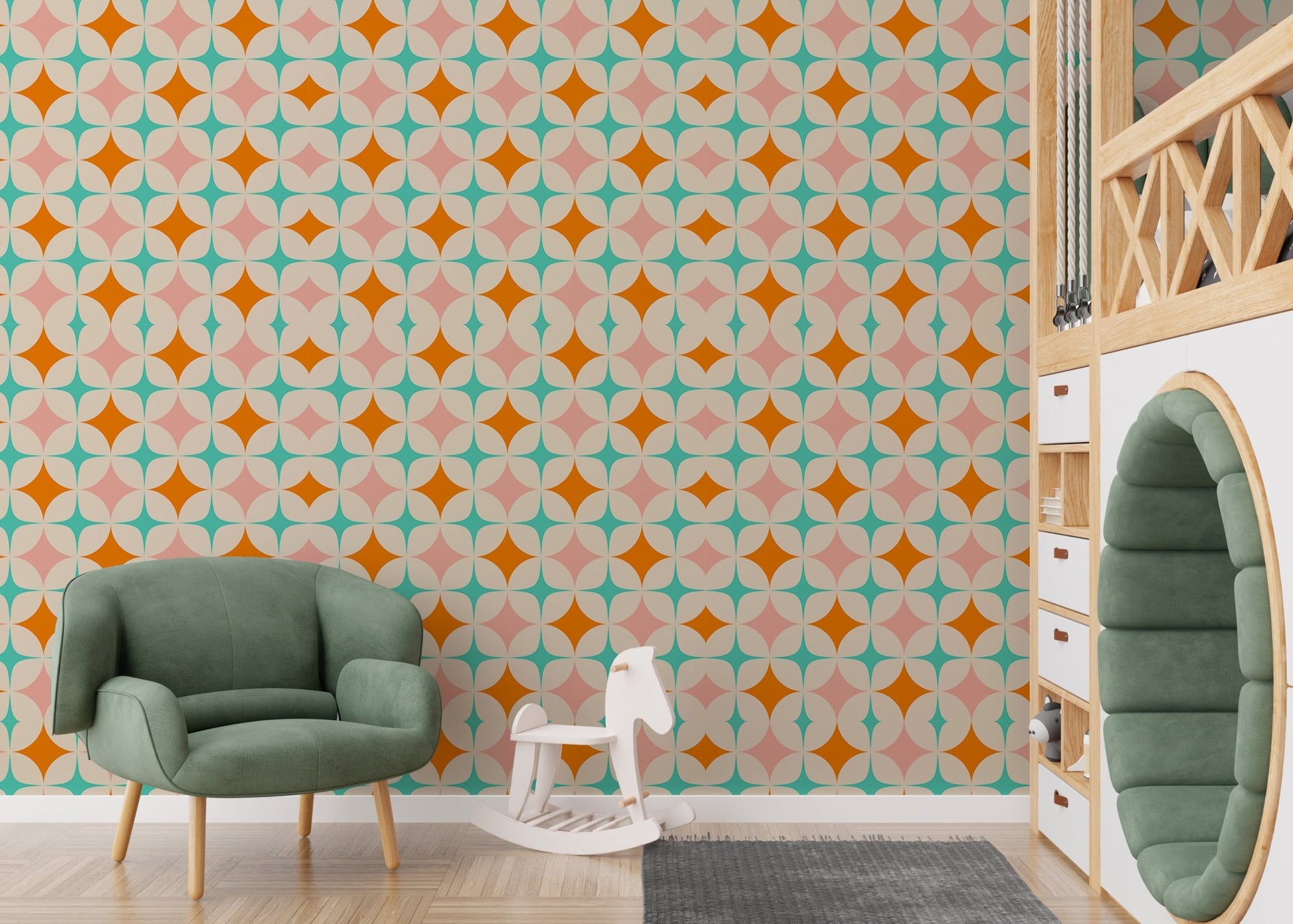Vintage pattern wall mural in a nursery with a green armchair and wooden toys.