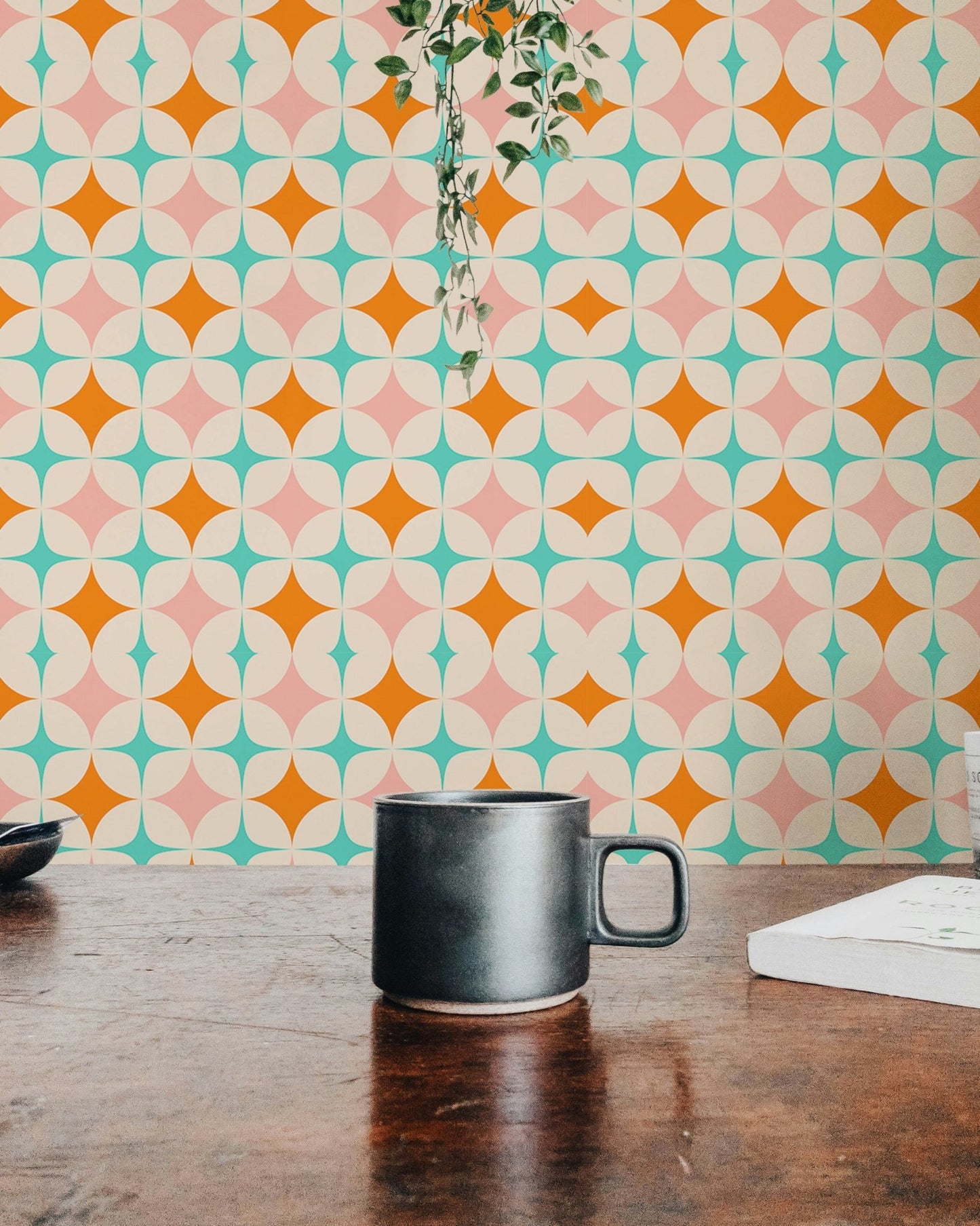 Vintage geometric art wall mural on a dining room wall near a dark ceramic mug.