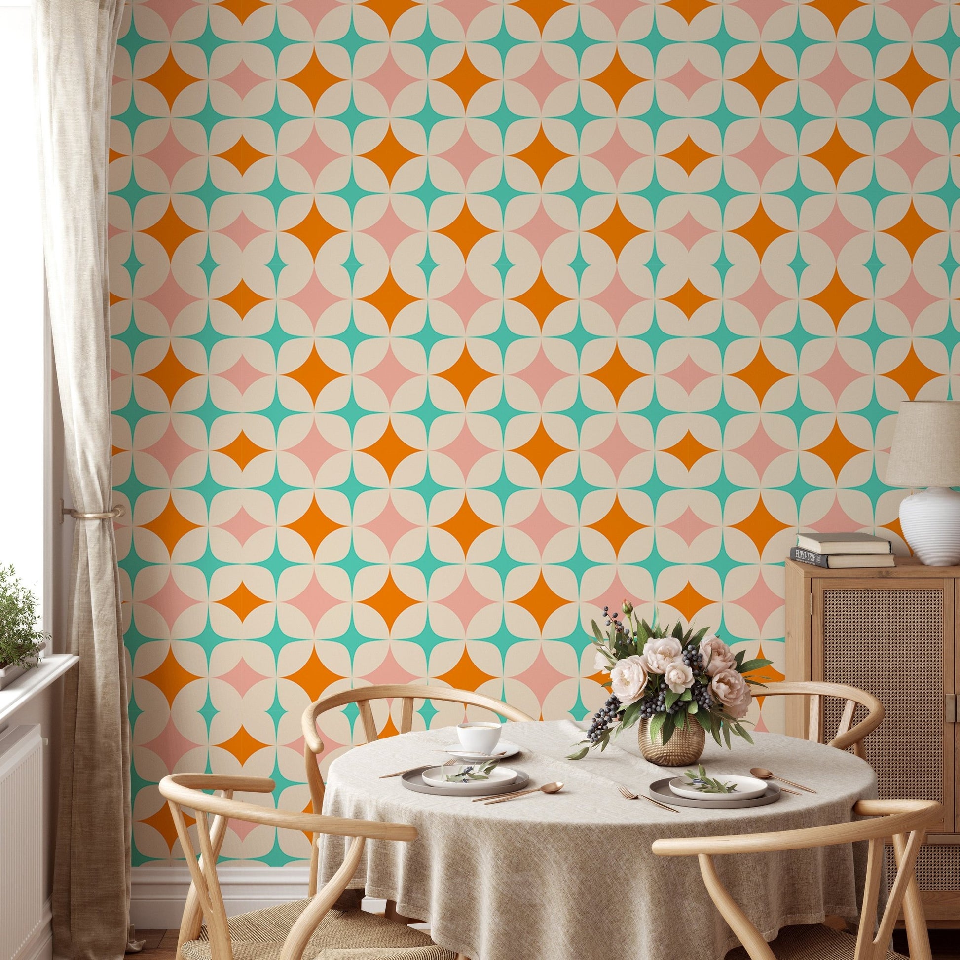 Starburst pattern wall mural in a breakfast nook with a round table and wooden chairs.