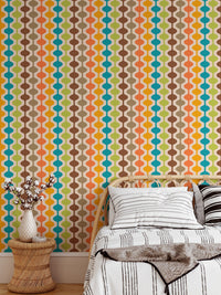 Teal and orange atomic pattern wall mural in a sunlit bedroom corner.