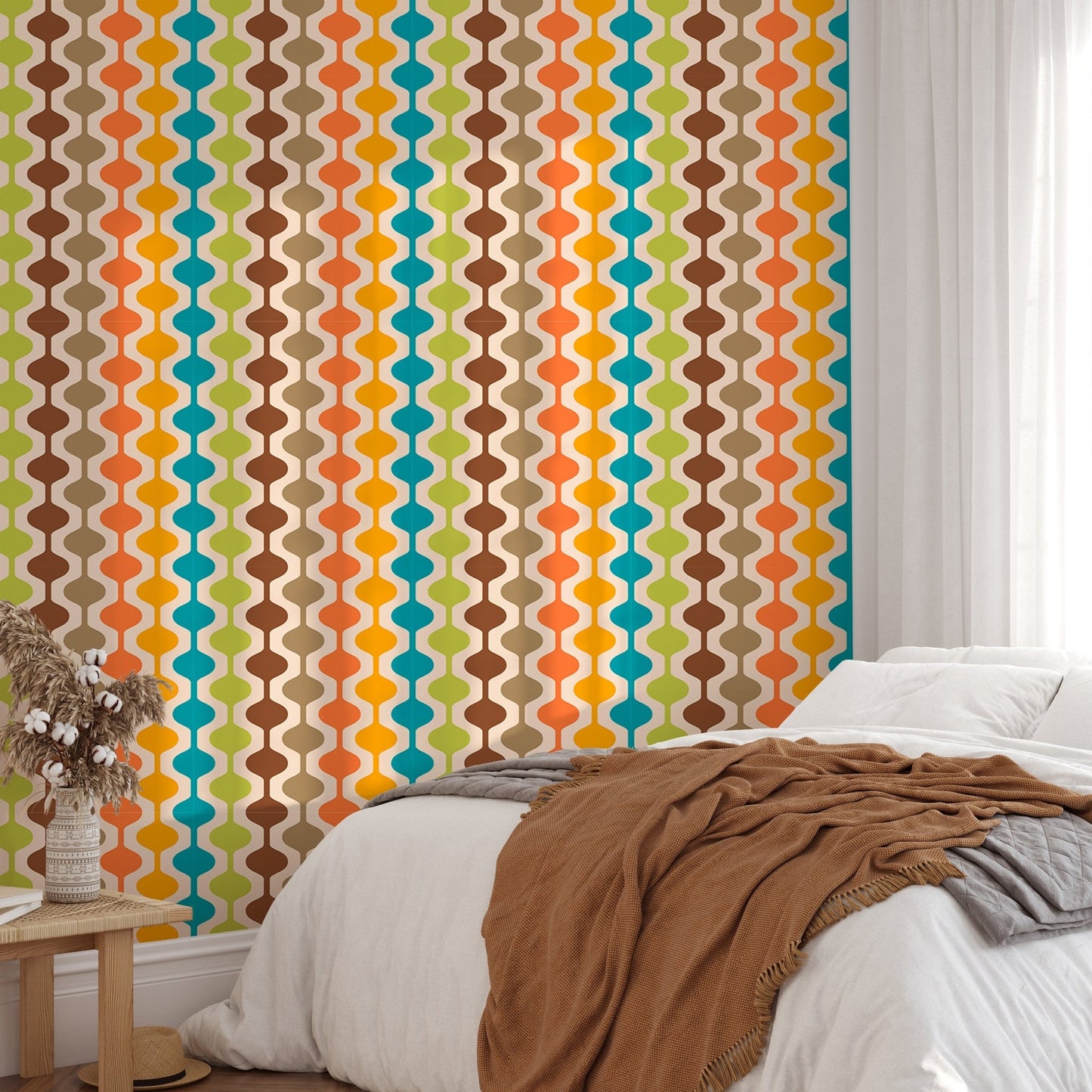 Multi-color vertical atomic pattern wall mural in a bedroom with white linens.