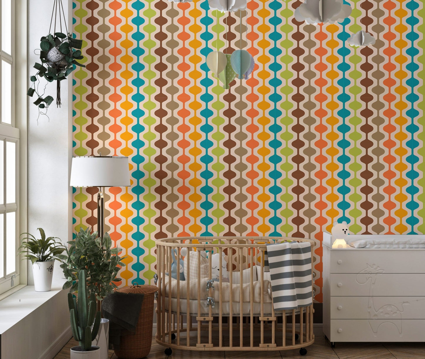 Vertical atomic pattern wall mural in a child's room with a wooden crib.