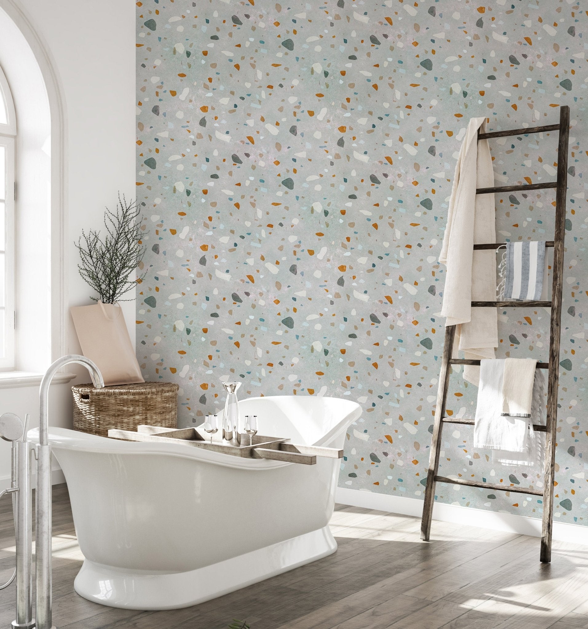 Bathroom featuring a white bathtub and terrazzo wallpaper with a wooden ladder shelf.