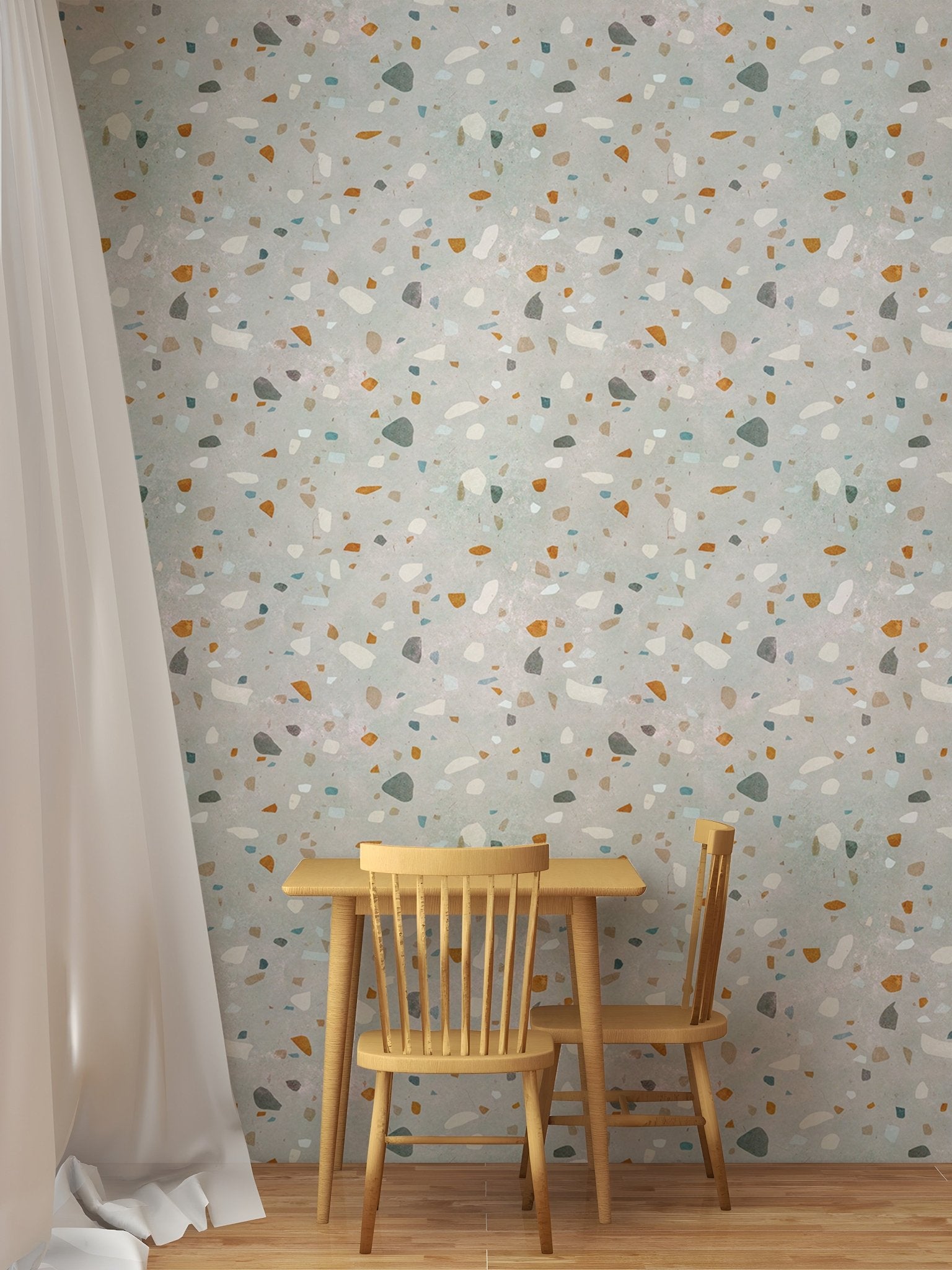 Small dining table and chair set against a multi-color terrazzo wallpaper background.