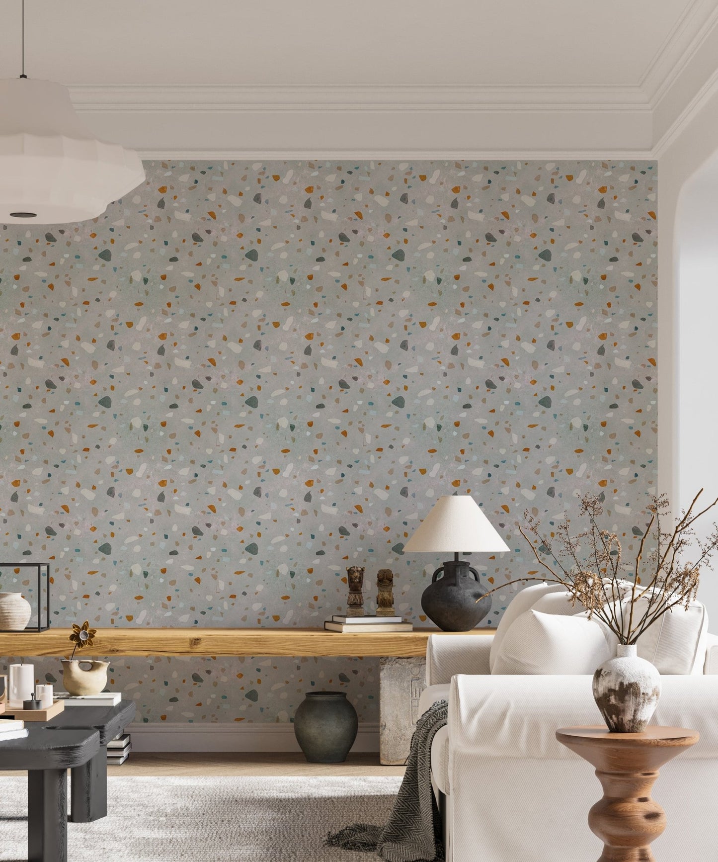 Living space with a white sofa and natural classic terrazzo wallpaper backdrop.