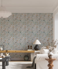 Living space with a white sofa and natural classic terrazzo wallpaper backdrop.