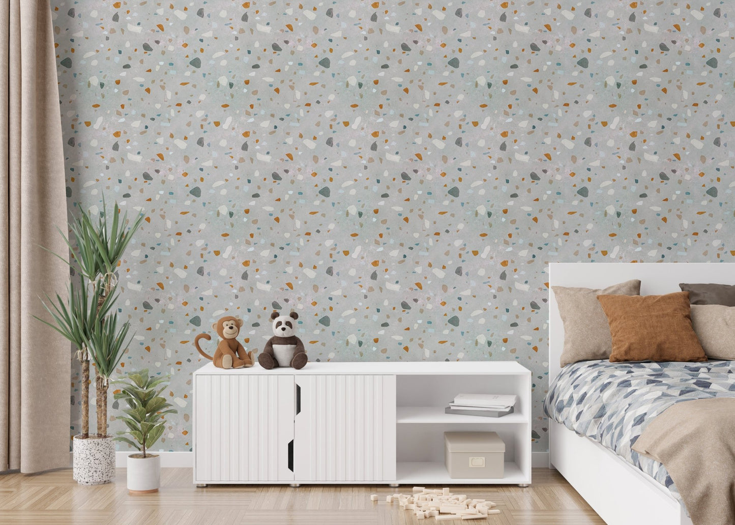Kids room with a white cabinet and terrazzo wallpaper with green plants.