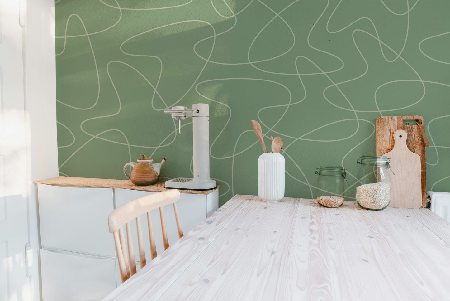 Sage green wall mural with retro squiggle line wallpaper pattern.