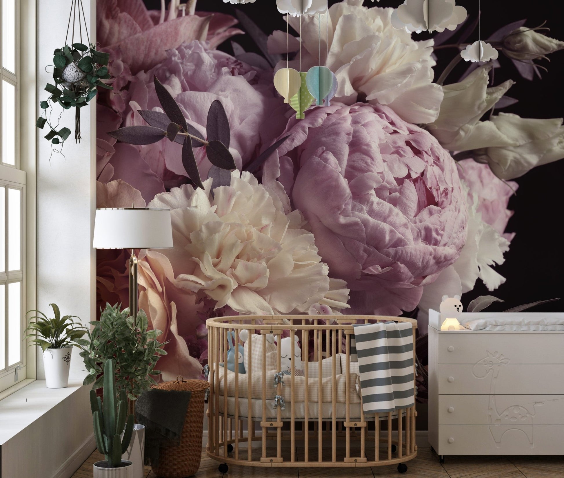 Pink flower garden wall mural in a nursery with a wooden crib and indoor plants.