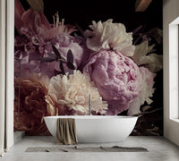 Dark floral garden wall mural in a bathroom with a white freestanding bathtub.