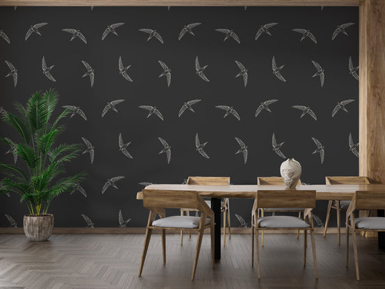 Midnight swallow bird wallpaper for dining room with white flying birds on dark charcoal background.