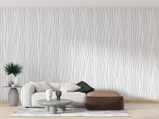 White wallpaper with vertical wave patterns in a bright sitting area.