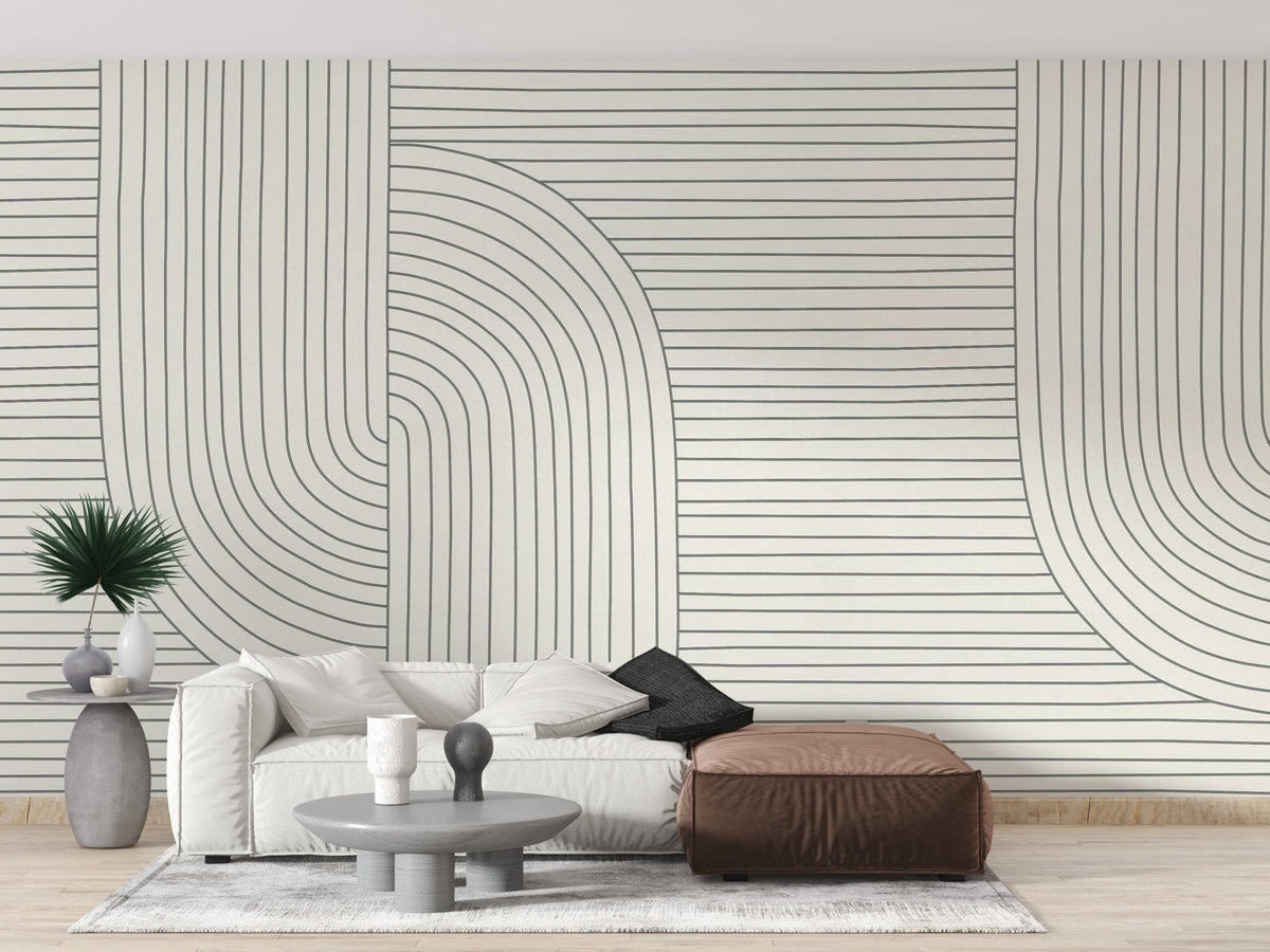 White and grey line art mural behind a cream sofa in a living room.