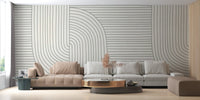 Geometric line art wall mural in a minimalist living room with grey seating.