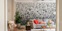 Geometric tiles wall mural in a living room behind a light beige sofa.