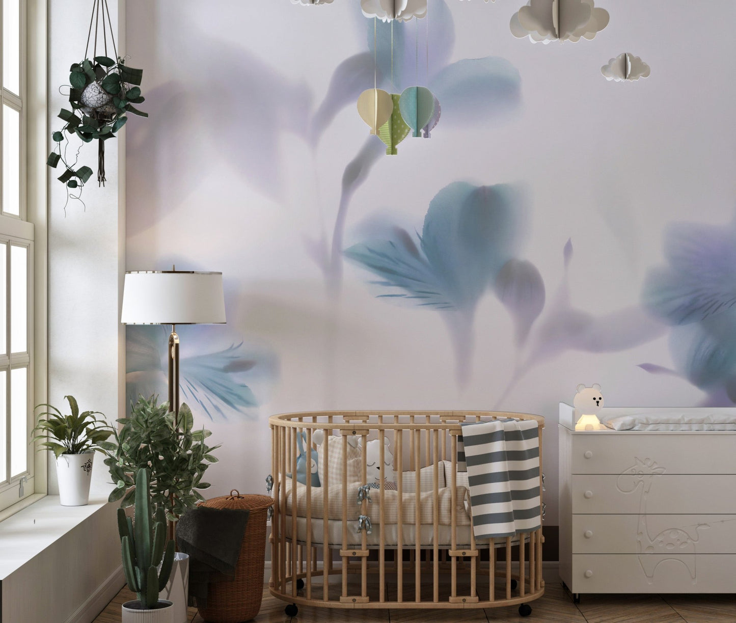 Nursery featuring a wooden crib against blue floral wall mural.