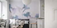 Minimalist living area with blurred orchid pattern wall mural and grey sofa.