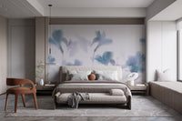 Dark modern bedroom with grey bed and blue orchid wall mural.