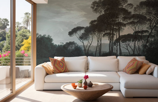 Deep green pine tree wall mural behind a white sectional sofa and coffee table.