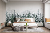 Watercolor evergreen tree wall mural behind a wooden bed frame with beige linen