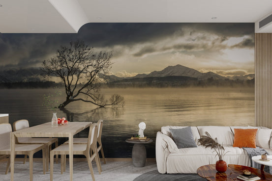 Scenic nature wallpaper with a solitary willow tree and mountain backdrop. 