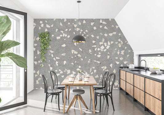 Large grey terrazzo marble pattern wall mural in a modern kitchen with black cabinetry.