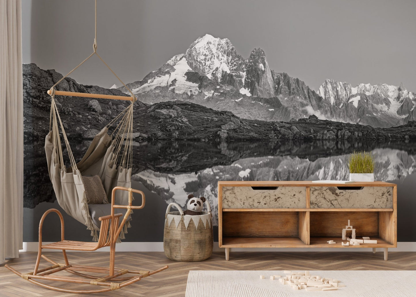 Misty mountain wall mural creating a serene ambiance in nursery.
