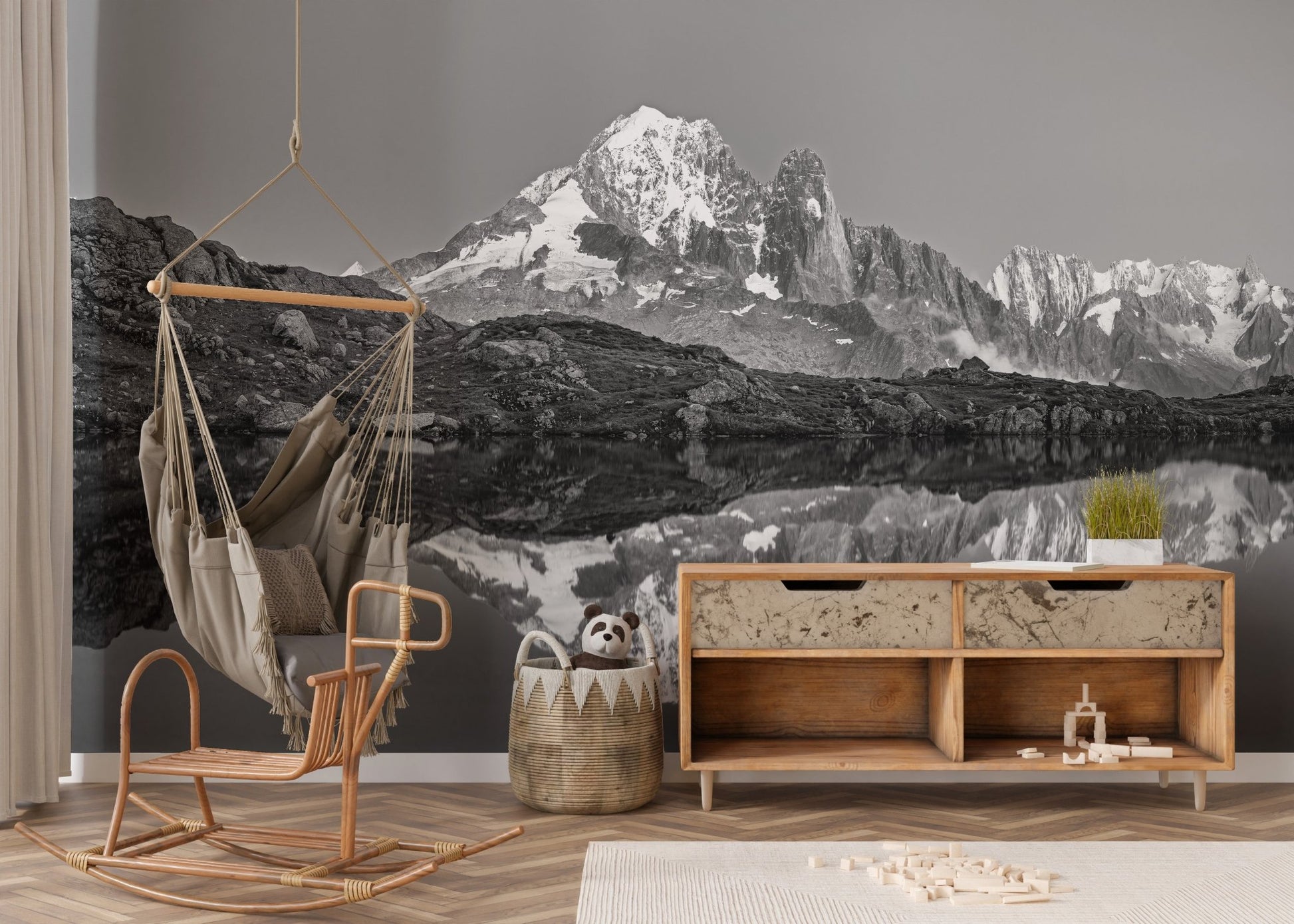 Misty mountain wall mural creating a serene ambiance in nursery.
