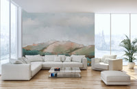 Watercolor mountain mural featuring a misty landscape in open living space.
