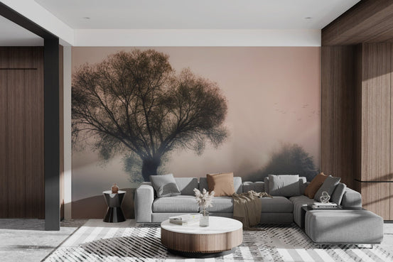 Misty solitary tree wallpaper in soft sunrise hues.