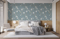 Elegant branch and blossom wallpaper with muted turquoise background.