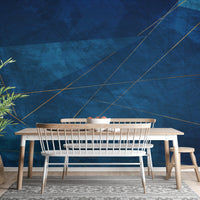 Navy blue abstract wall mural behind a dining table with wooden chairs and bench.