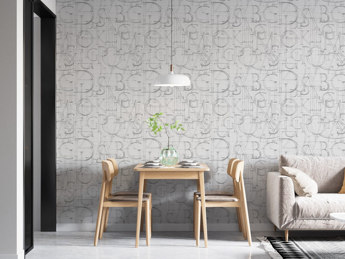 Grey alphabet wallpaper in a dining space with a hanging light fixture.