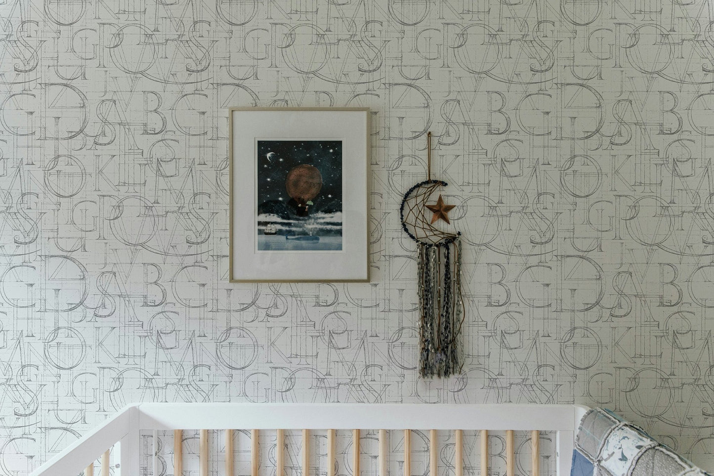 Modern Roman Classic Alphabet Method Geometric Wallpaper in a nursery above a white crib.