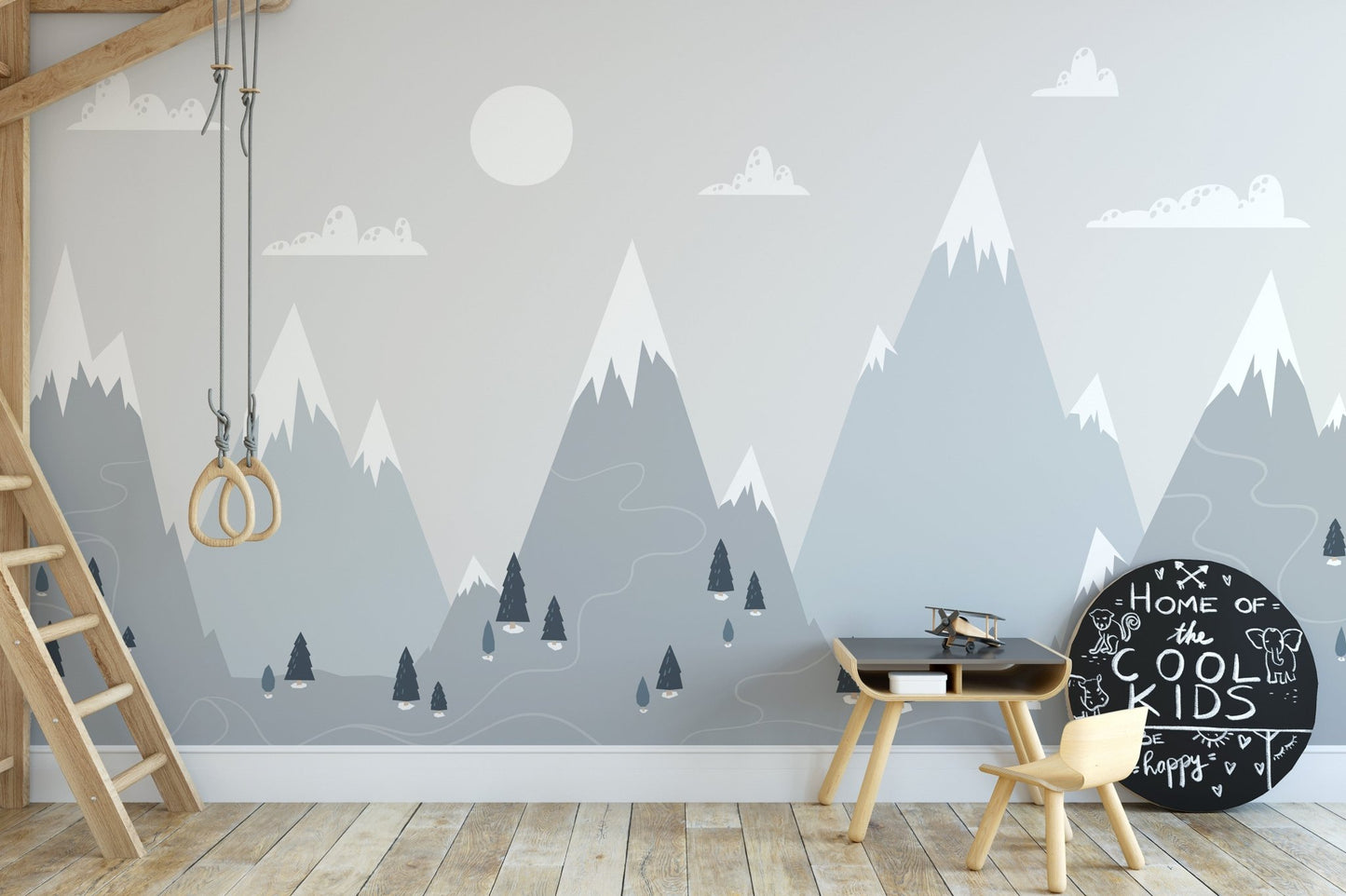 Playroom wall mural with scandinavian mountain design and a small wooden climbing frame.