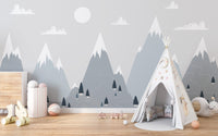 Minimalist mountain charm wall mural in a bedroom featuring a white teepee tent.