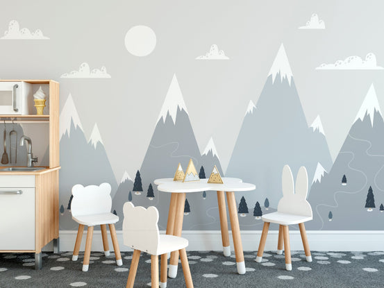 Kids study area wall mural with alpine mountain peaks and small wooden desk.