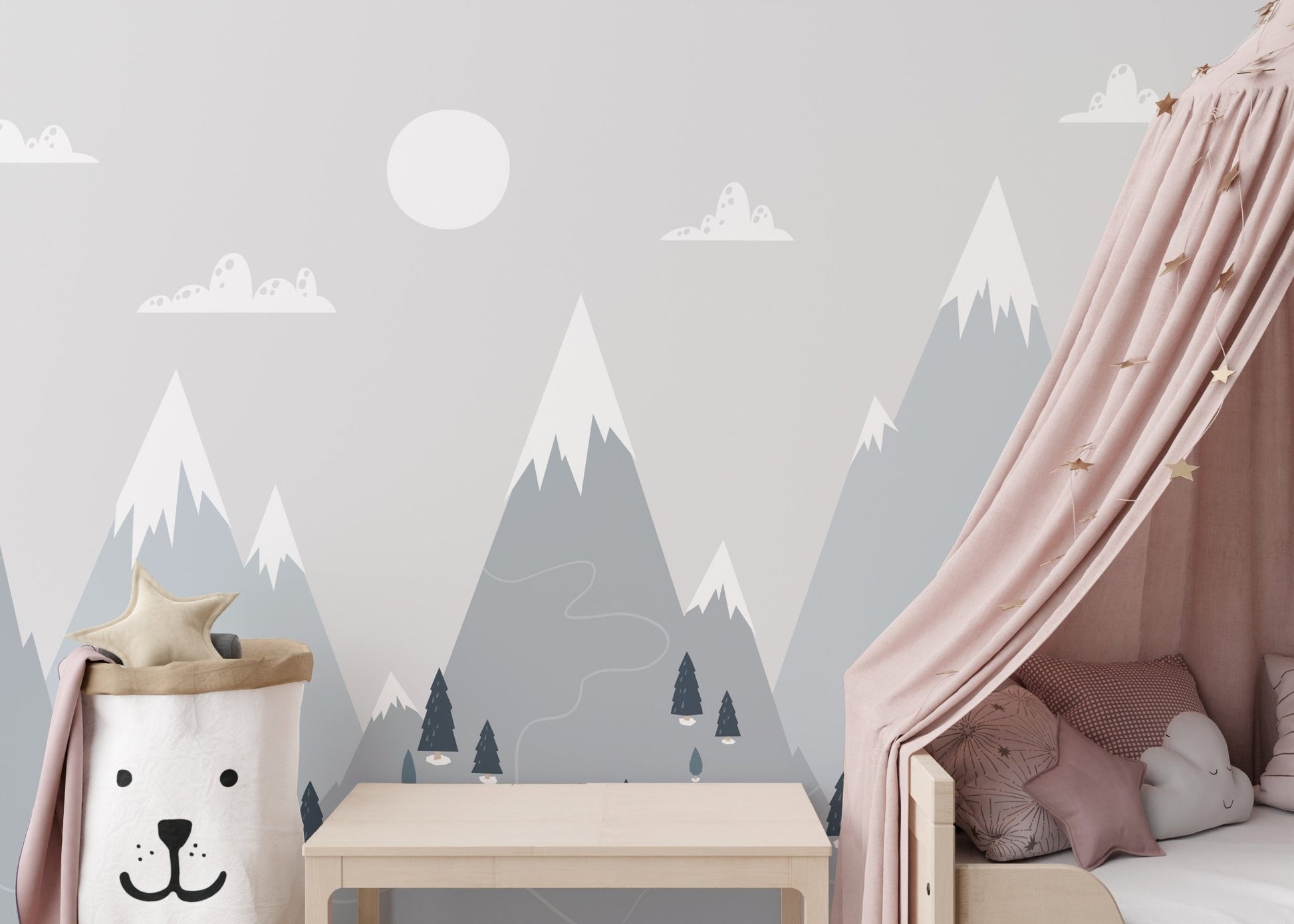 Soft grey alpine wall mural behind a toddler bed with pink accents.