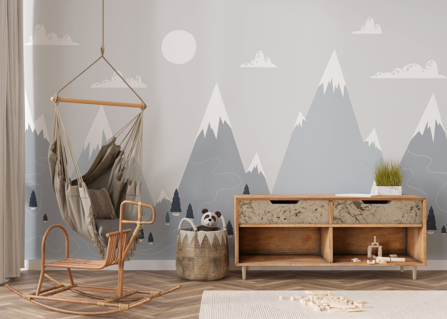 Nursery wall mural featuring blue alpine  and a hanging wicker chair.