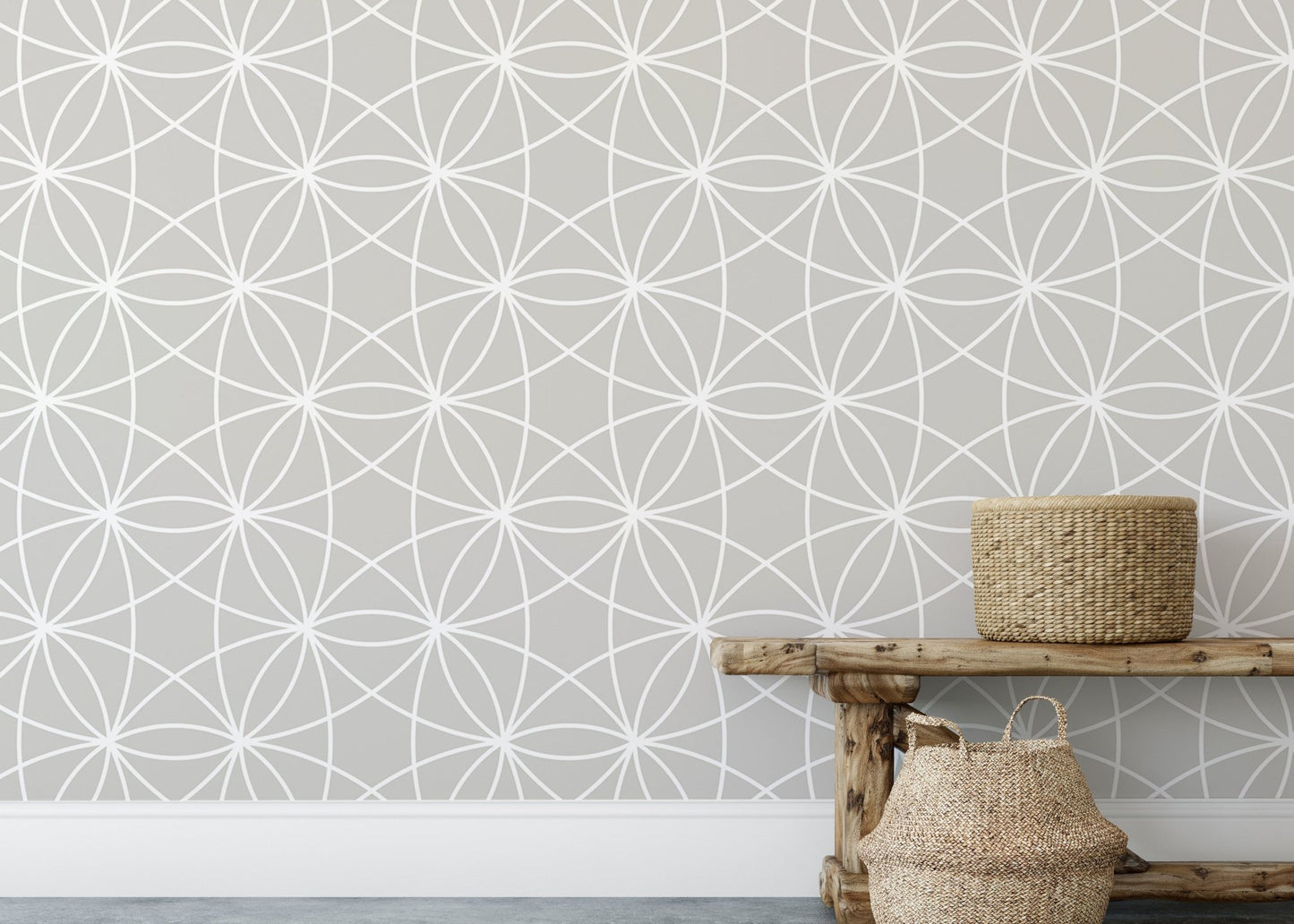 Grey and white geometric wallpaper styled with a rustic wooden bench.